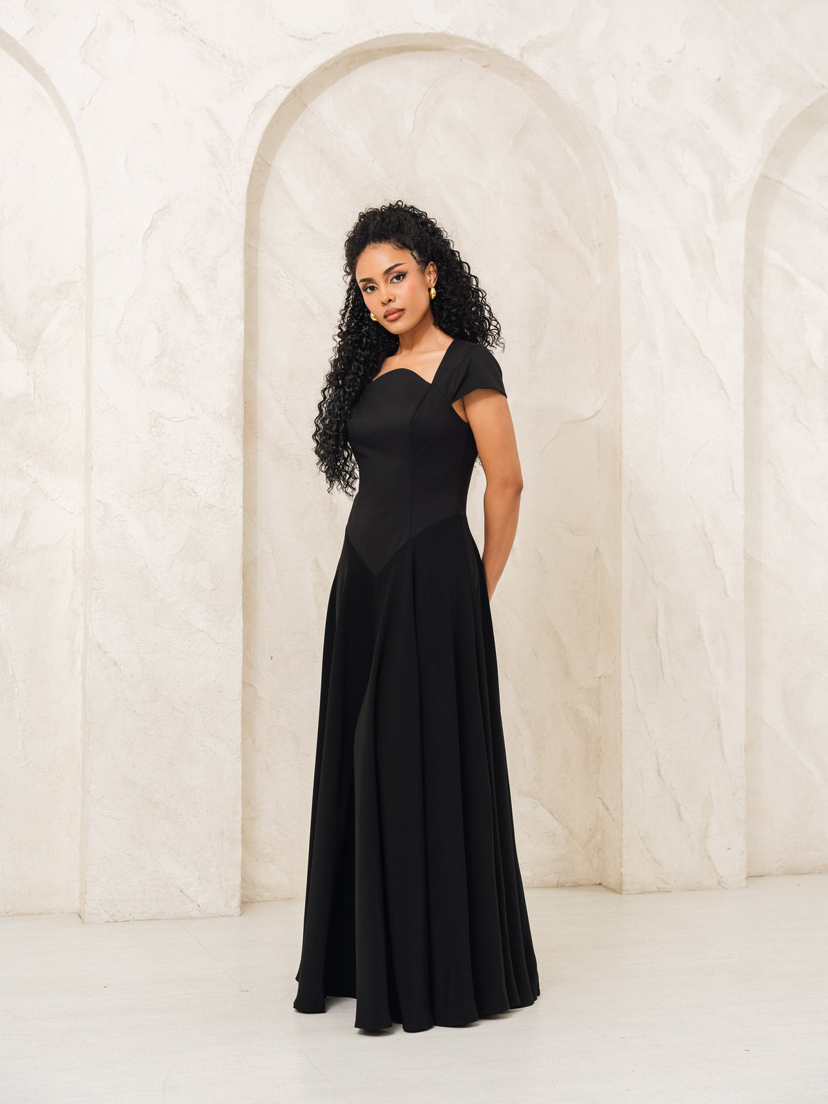 Fleur Elize Aurora black capsleeve flowy maxi dress front view elegant evening silhouette