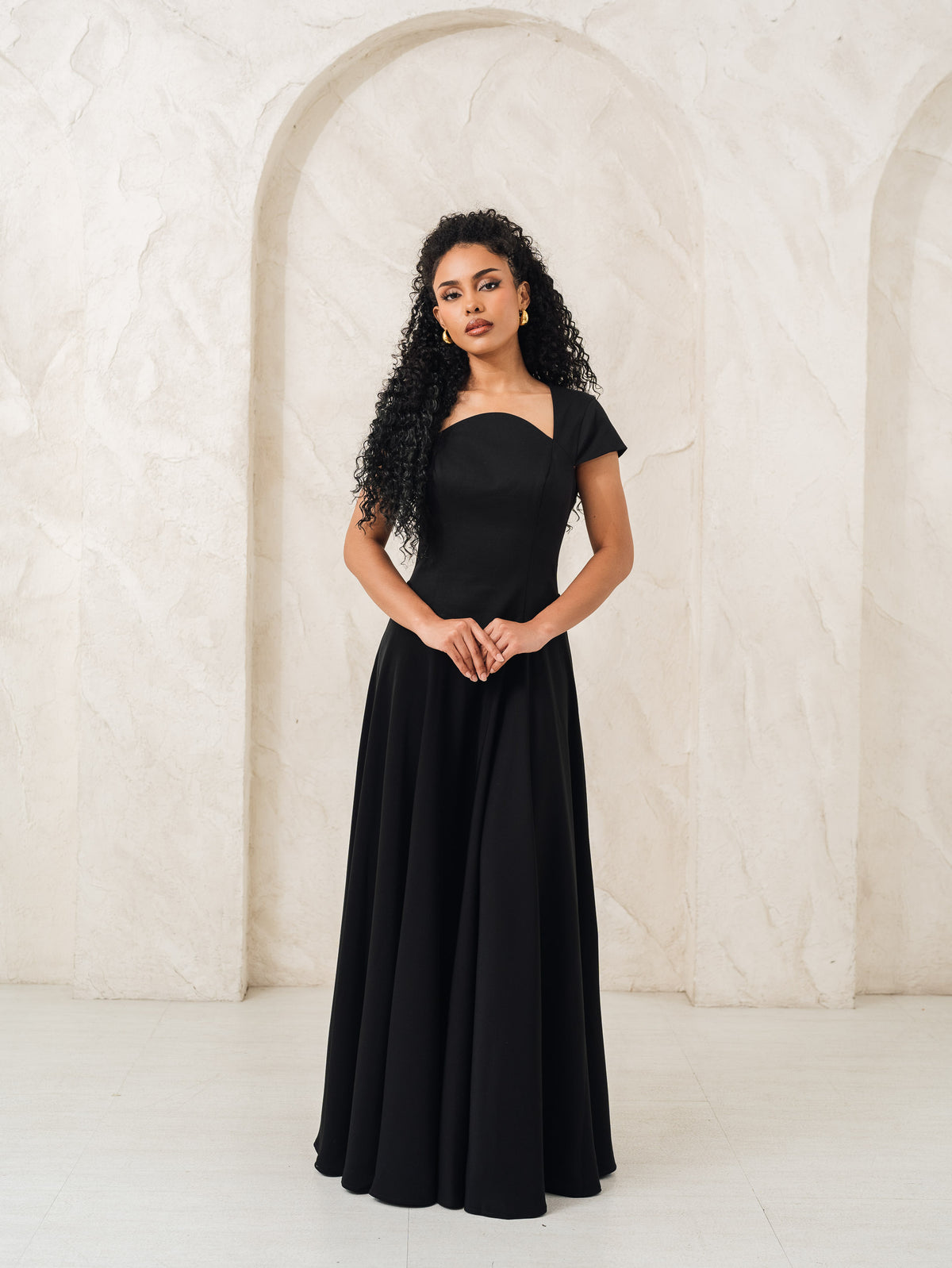 Fleur Elize Aurora black capsleeve flowy maxi dress front view elegant evening silhouette