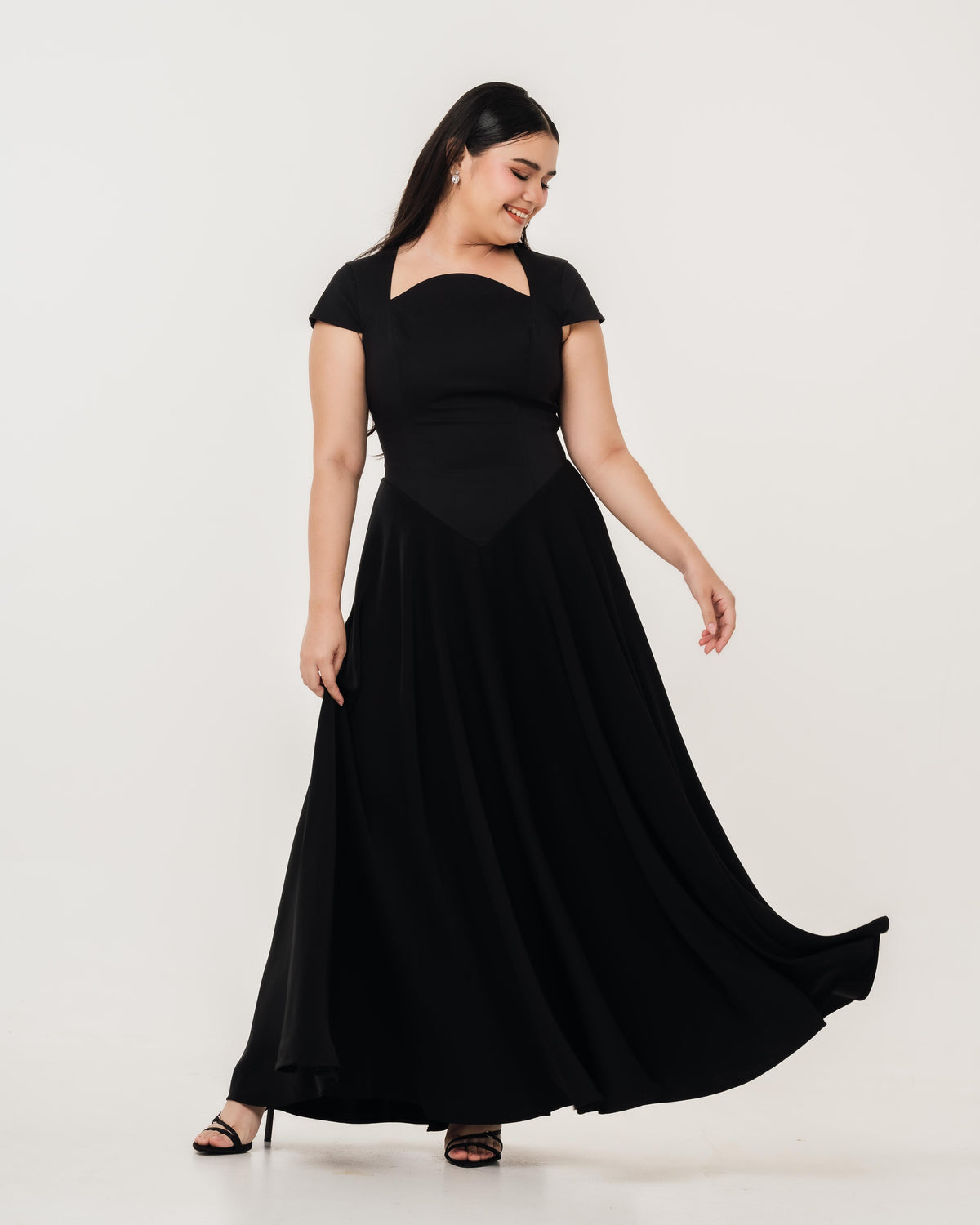 Fleur Elize Aurora black capsleeve flowy maxi dress front view elegant evening silhouette