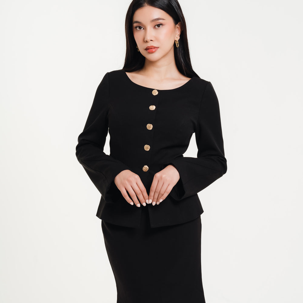 Fleur Elize black long-sleeve midi dress with gold button accents — close-up view of elegant women’s boutique fashion photographed in a minimalist studio setting