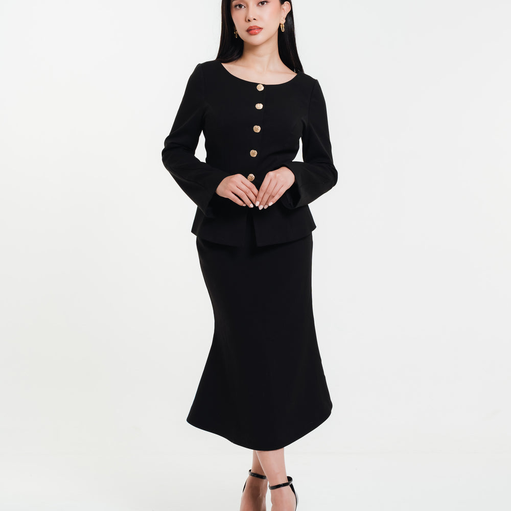 Fleur Elize black mermaid skirt with matching long-sleeve top featuring gold buttons — modern minimalist look