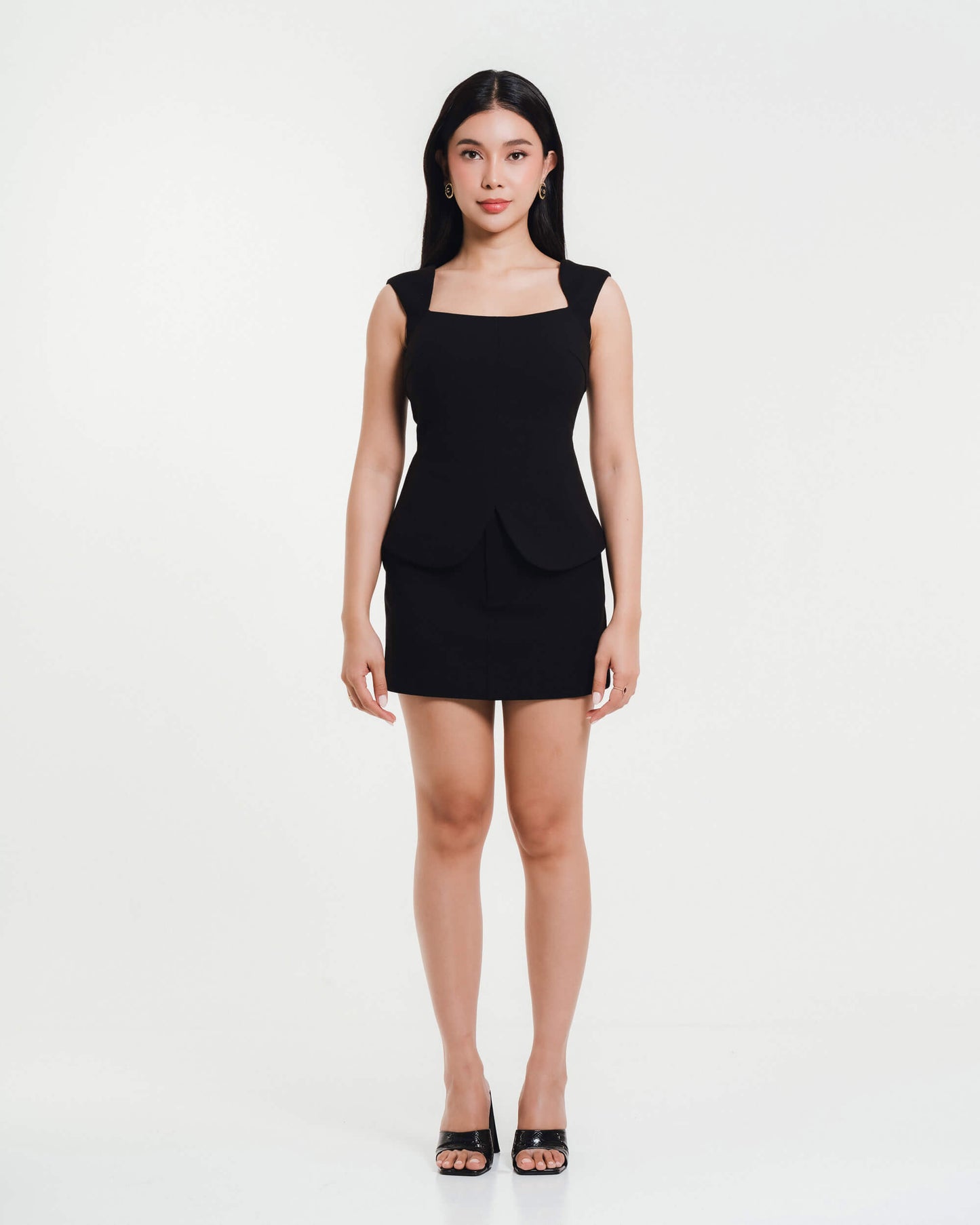 Fleur Elize black square-neck peplum top and mini skirt — elegant women’s boutique outfit photographed in minimalist studio